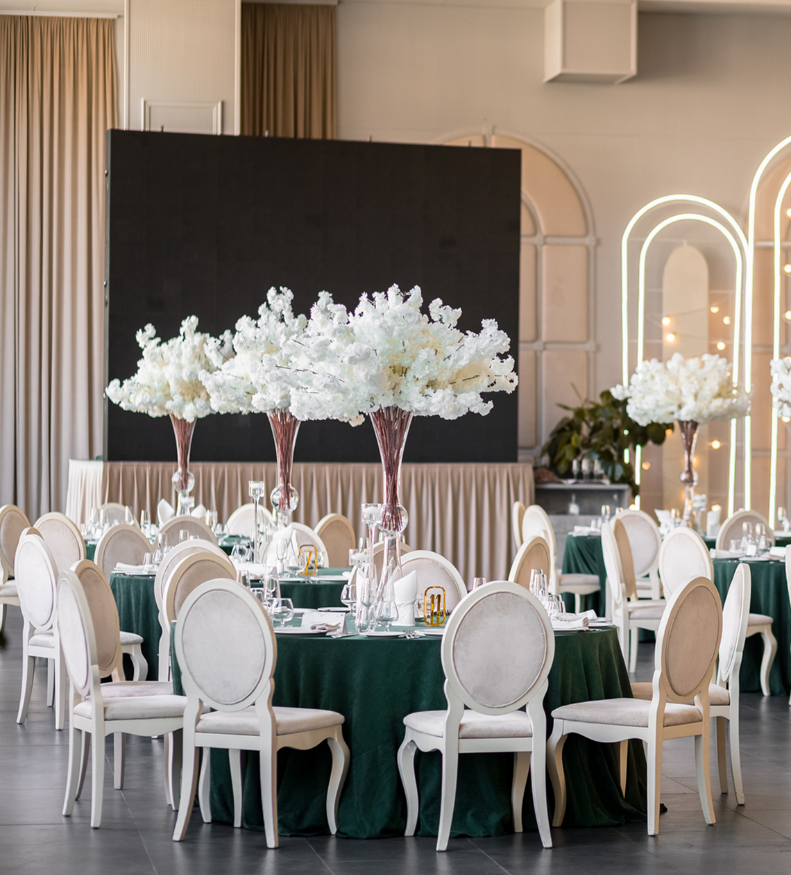 Elegant banquet hall with floral centerpieces.