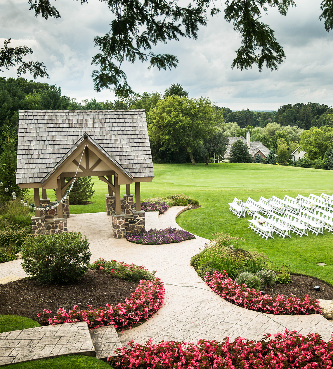 Outdoor wedding setup with chairs and gazebo.